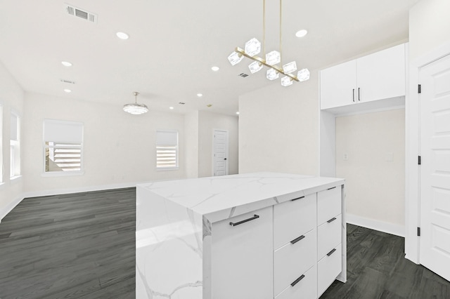 3632 Dreyfus St, Houston, TX 77021 - kitchen featuring white cabinetry, dark wood finished floors, modern cabinets, hanging light fixtures, and a kitchen island