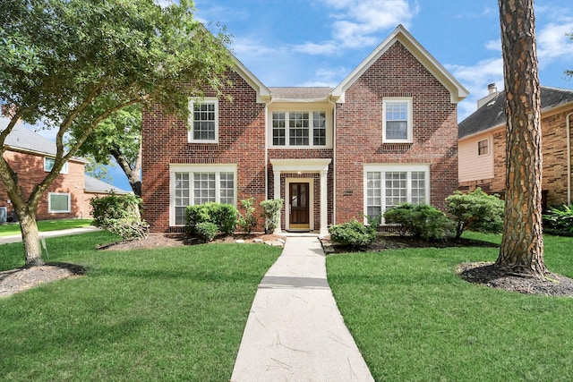 4311 Roaring Rapids Dr, Pasadena, TX 77059 - colonial house with brick siding and a front yard