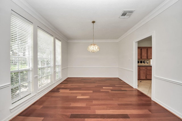 4311 Roaring Rapids Dr, Pasadena, TX 77059 - unfurnished dining area with a chandelier, wood finished floors, and ornamental molding