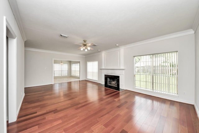 4311 Roaring Rapids Dr, Pasadena, TX 77059 - unfurnished living room with ceiling fan, a fireplace, crown molding, healthy amount of natural light, and wood finished floors