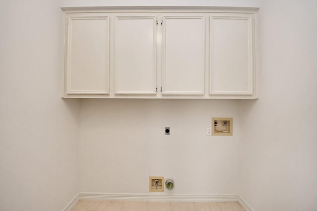 4311 Roaring Rapids Dr, Pasadena, TX 77059 - laundry room with hookup for an electric dryer, hookup for a washing machine, baseboards, and cabinet space
