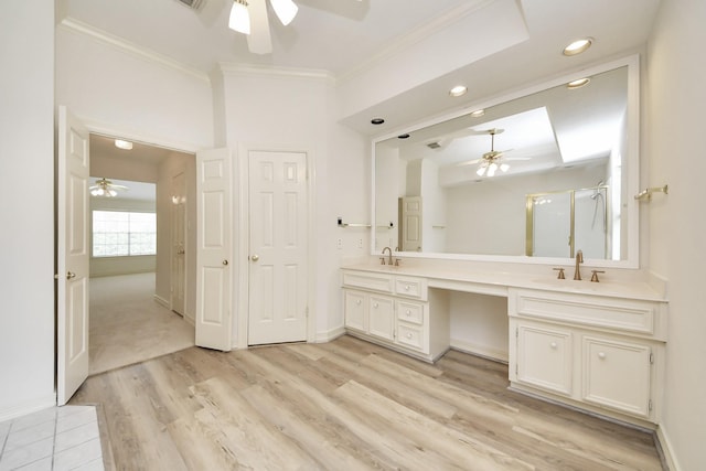 4311 Roaring Rapids Dr, Pasadena, TX 77059 - bathroom with ceiling fan, ornamental molding, double vanity, a shower stall, and wood finished floors