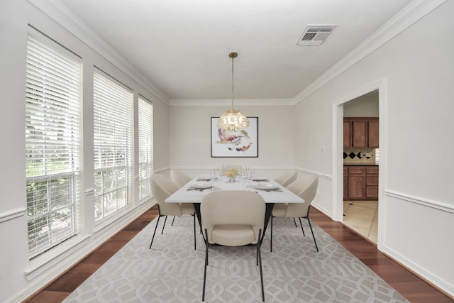 4311 Roaring Rapids Dr, Pasadena, TX 77059 - dining space with wood finished floors, a chandelier, and crown molding