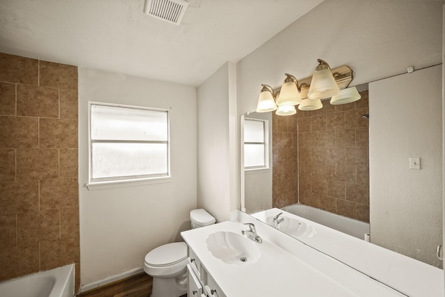 231 Gruss Dr, Houston, TX 77060 - full bath featuring toilet, vanity, shower / tub combination, and wood finished floors