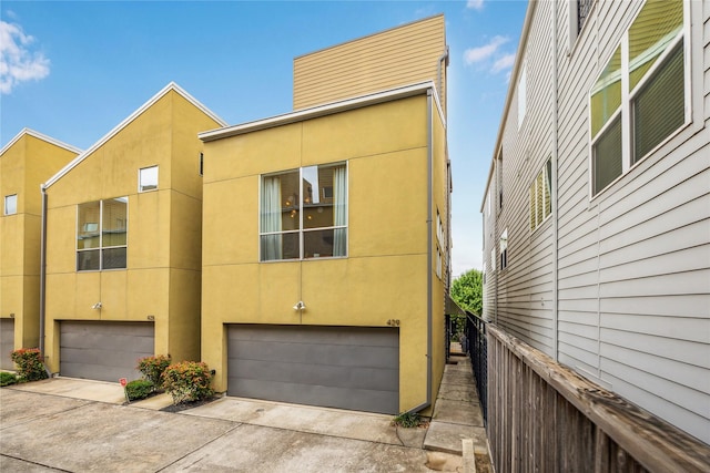 429 Meadow St, Houston, TX 77020 - view of home's exterior featuring a garage, driveway, and stucco siding