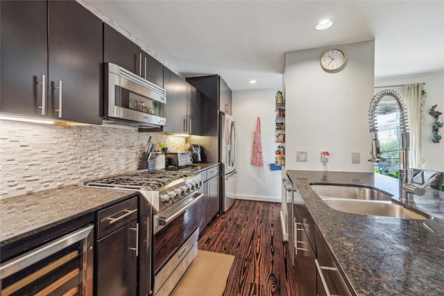 429 Meadow St, Houston, TX 77020 - kitchen with appliances with stainless steel finishes, wine cooler, a sink, dark stone counters, and dark wood-style floors