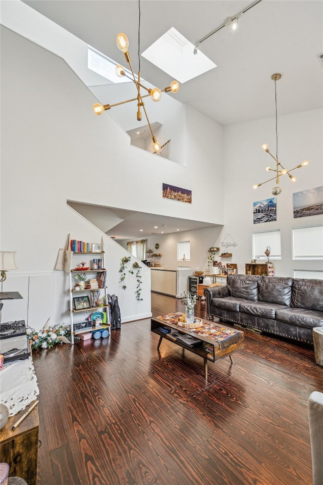 429 Meadow St, Houston, TX 77020 - living area with a chandelier, a skylight, high vaulted ceiling, and wood finished floors