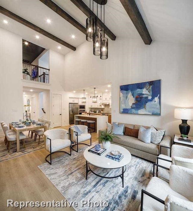 2296 Vargas St, Magnolia, TX 77316 - living area featuring light wood-type flooring, beamed ceiling, a high ceiling, and recessed lighting