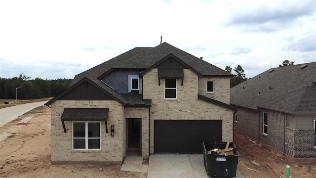 2296 Vargas St, Magnolia, TX 77316 - view of front of home with driveway, brick siding, an attached garage, and roof with shingles