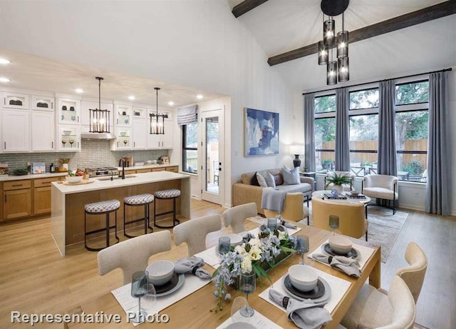 2296 Vargas St, Magnolia, TX 77316 - dining room featuring a chandelier, light wood-type flooring, recessed lighting, beamed ceiling, and a towering ceiling