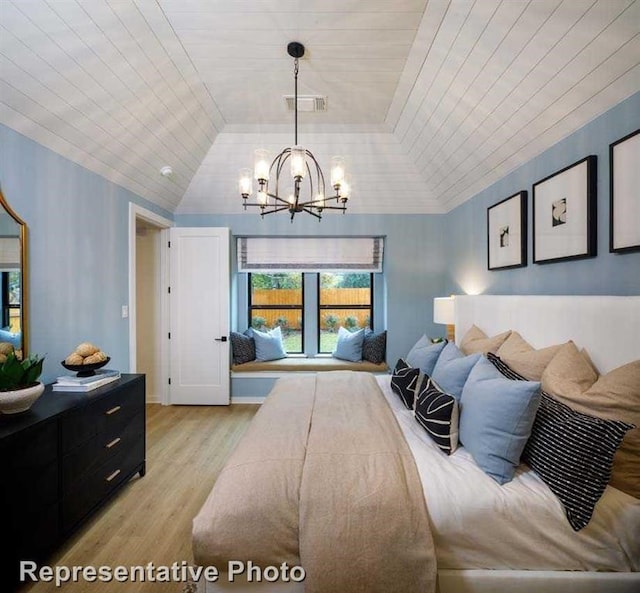 2296 Vargas St, Magnolia, TX 77316 - bedroom with a chandelier, light wood-style floors, and vaulted ceiling