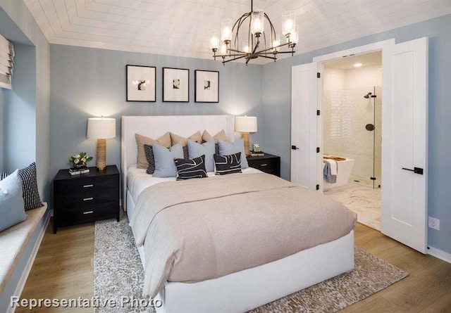 2296 Vargas St, Magnolia, TX 77316 - bedroom with a chandelier, wood finished floors, baseboards, and ensuite bathroom