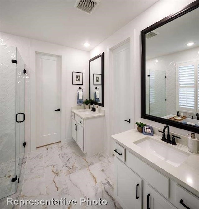 2296 Vargas St, Magnolia, TX 77316 - bathroom featuring a marble finish shower, two vanities, marble finish floors, and recessed lighting