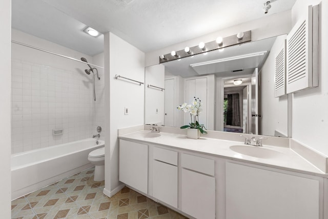 10053 Westpark Dr Unit 332, Houston, TX 77042 - full bathroom featuring double vanity, toilet, bathing tub / shower combination, and tile patterned floors