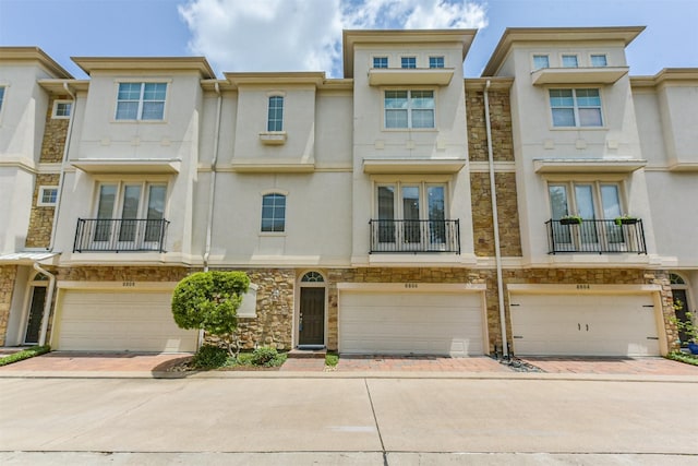 8806 Lakeshore Bend Dr, Houston, TX 77080 - townhome / multi-family property with stucco siding, stone siding, and an attached garage