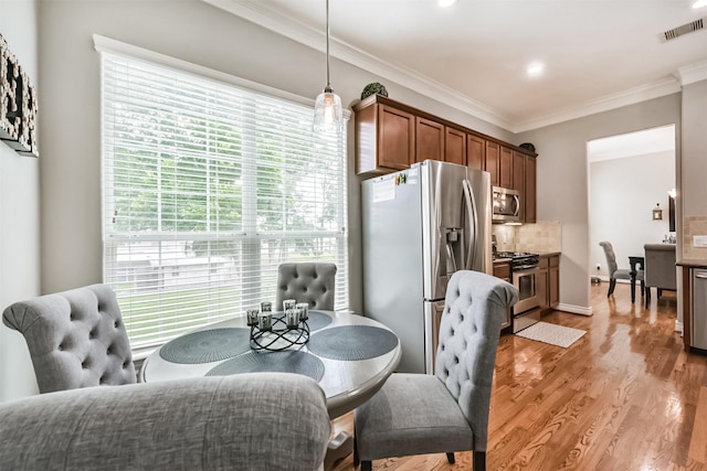 8806 Lakeshore Bend Dr, Houston, TX 77080 - dining room with crown molding, light wood finished floors, and recessed lighting