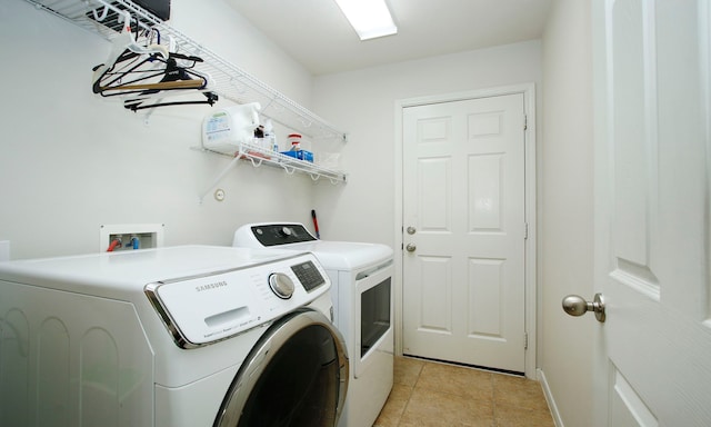 2726 Redwick Dr, Spring, TX 77388 - laundry room featuring washer and clothes dryer and light tile patterned floors