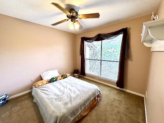 3823 Knollcrest Dr, Montgomery, TX 77356 - carpeted bedroom featuring baseboards and ceiling fan