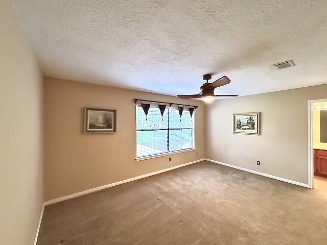 3823 Knollcrest Dr, Montgomery, TX 77356 - carpeted spare room featuring a textured ceiling, baseboards, and ceiling fan