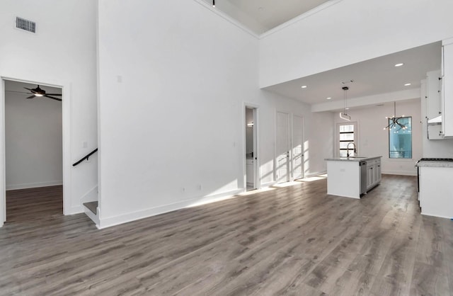 5609 Savyon Dr, Houston, TX 77091 - unfurnished living room with a sink, light wood-type flooring, ceiling fan, recessed lighting, and baseboards