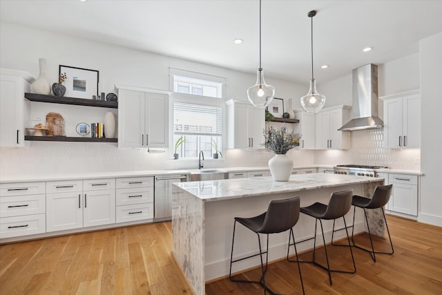 1402 Missouri Unit B, Houston, TX 77006 - kitchen with wall chimney exhaust hood, stainless steel dishwasher, open shelves, a kitchen island, and white cabinets