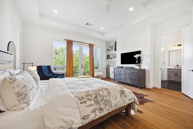 1402 Missouri Unit B, Houston, TX 77006 - bedroom featuring wood finished floors, a raised ceiling, recessed lighting, ensuite bath, and a sink
