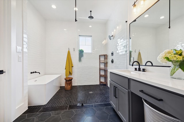 1402 Missouri Unit B, Houston, TX 77006 - bathroom featuring tile patterned floors, vanity, a freestanding tub, a walk in shower, and recessed lighting