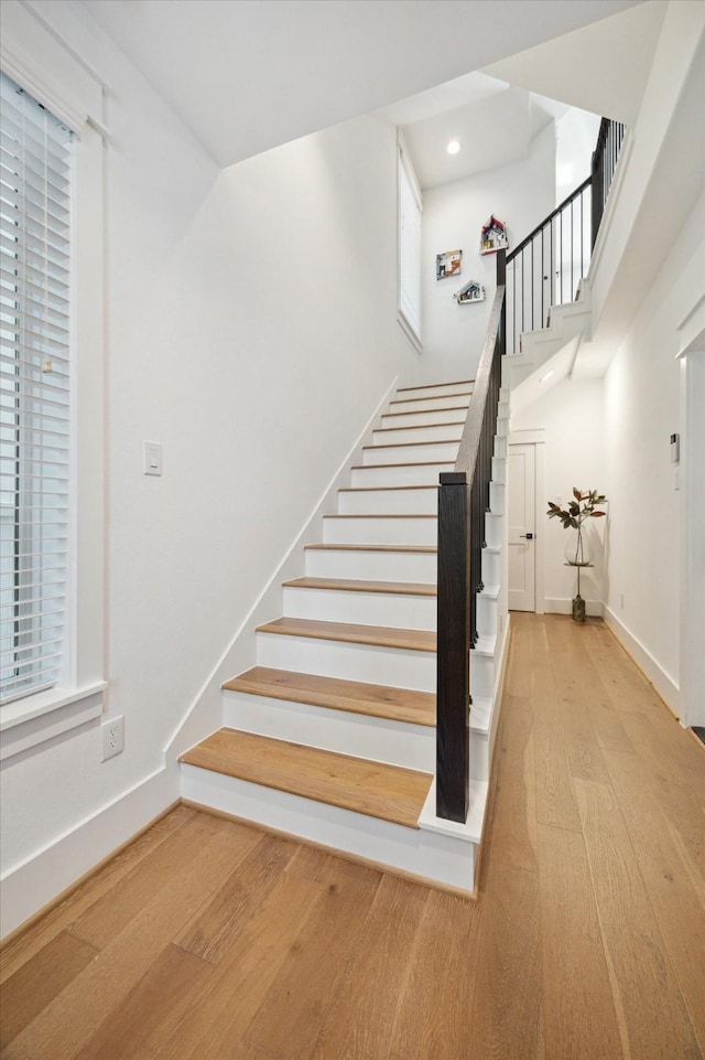 1402 Missouri Unit B, Houston, TX 77006 - stairway featuring wood finished floors, baseboards, a towering ceiling, and recessed lighting
