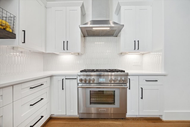 1402 Missouri Unit B, Houston, TX 77006 - kitchen with stainless steel range, wall chimney exhaust hood, light countertops, and white cabinetry
