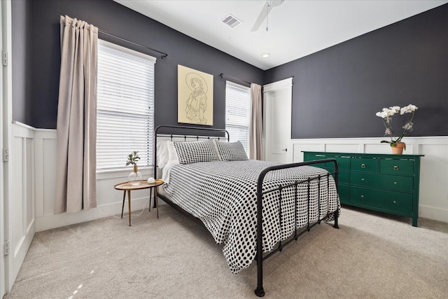 1402 Missouri Unit B, Houston, TX 77006 - bedroom featuring light carpet, a decorative wall, a wainscoted wall, and ceiling fan
