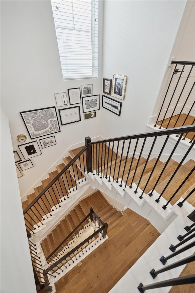 1402 Missouri Unit B, Houston, TX 77006 - staircase with wood finished floors and a towering ceiling