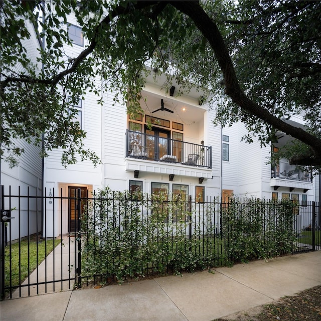 1402 Missouri Unit B, Houston, TX 77006 - view of front of house featuring a fenced front yard, a balcony, and a gate