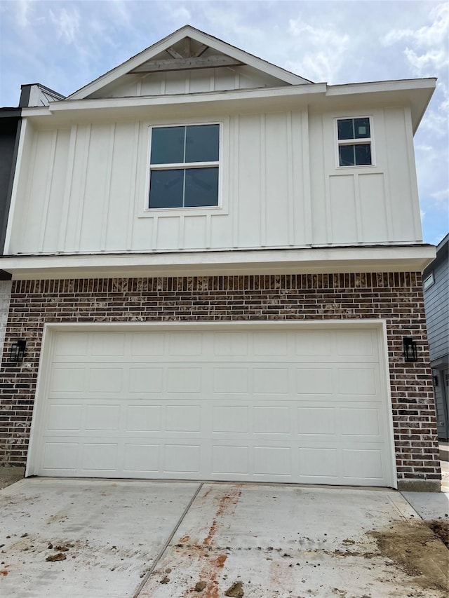118 Capetown, Conroe, TX 77356 - view of front of house featuring brick siding, board and batten siding, and concrete driveway