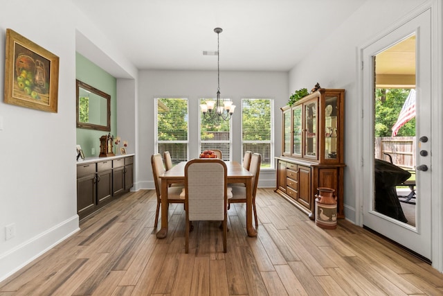 204 Terrain View Ct, Willis, TX 77318 - dining space with a chandelier, plenty of natural light, light wood-style floors, and baseboards