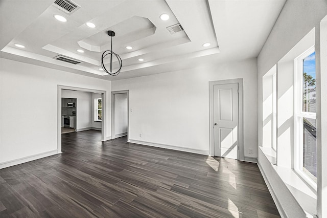 102 Glendale St, Houston, TX 77012 - unfurnished room with a raised ceiling, dark wood finished floors, recessed lighting, and baseboards