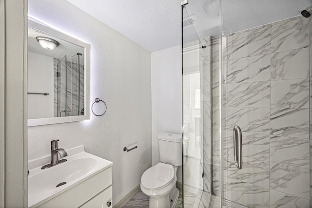 102 Glendale St, Houston, TX 77012 - bathroom featuring marble finish floors, a shower stall, vanity, toilet, and a textured ceiling