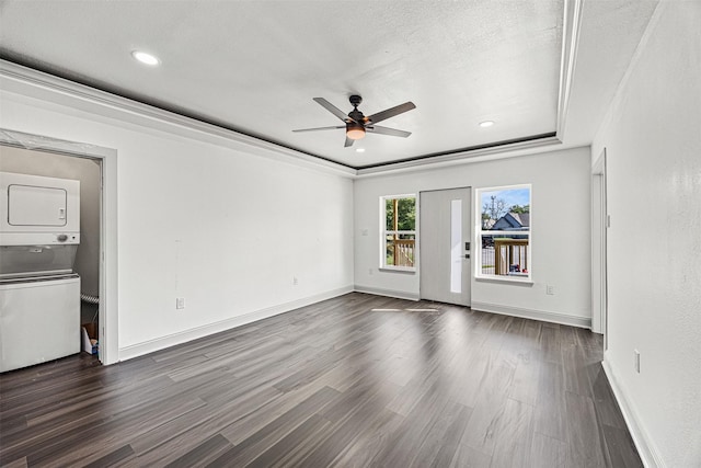102 Glendale St, Houston, TX 77012 - empty room featuring stacked washing machine and dryer, ceiling fan, dark wood-style flooring, baseboards, and recessed lighting