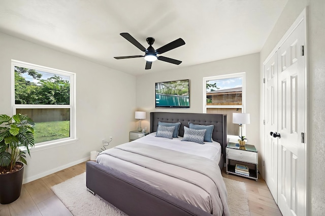 5607 Flamingo Dr, Houston, TX 77033 - bedroom with light wood-style flooring, baseboards, a closet, and ceiling fan