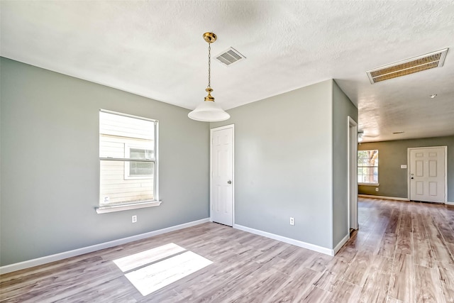 19747 Byron Meadows Dr, Katy, TX 77449 - unfurnished room with wood finished floors, baseboards, and a textured ceiling