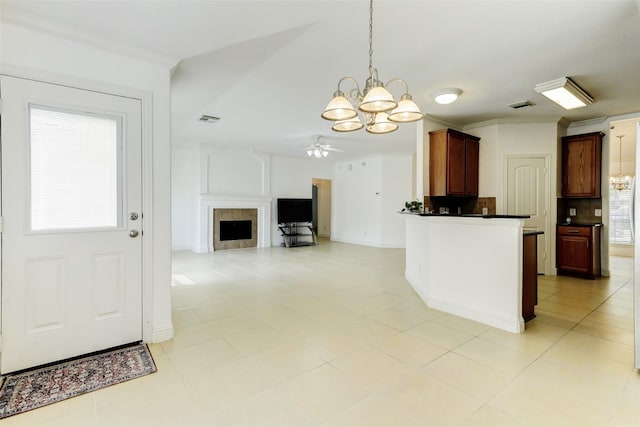 316 Magnolia Way, League City, TX 77573 - kitchen with a chandelier, dark countertops, pendant lighting, a fireplace, and ceiling fan