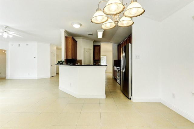 316 Magnolia Way, League City, TX 77573 - kitchen with freestanding refrigerator, open floor plan, dark countertops, ceiling fan, and light tile patterned floors