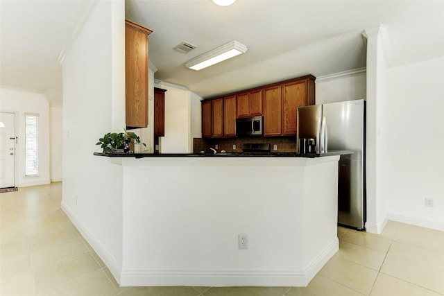 316 Magnolia Way, League City, TX 77573 - kitchen featuring stainless steel appliances, crown molding, dark countertops, light tile patterned flooring, and decorative backsplash