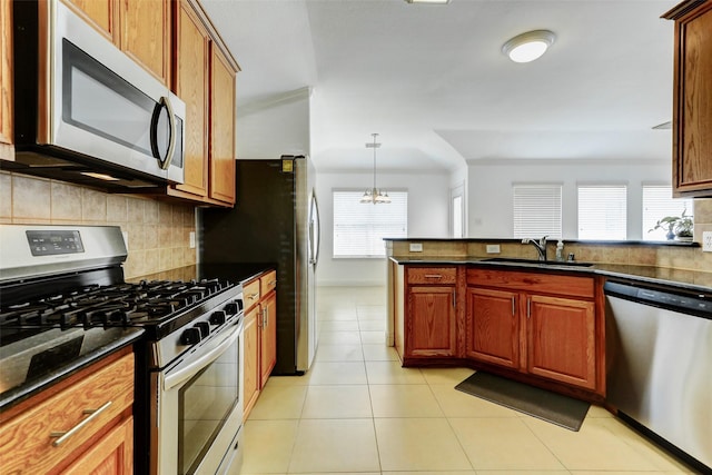 316 Magnolia Way, League City, TX 77573 - kitchen with stainless steel appliances, a sink, healthy amount of natural light, and tasteful backsplash