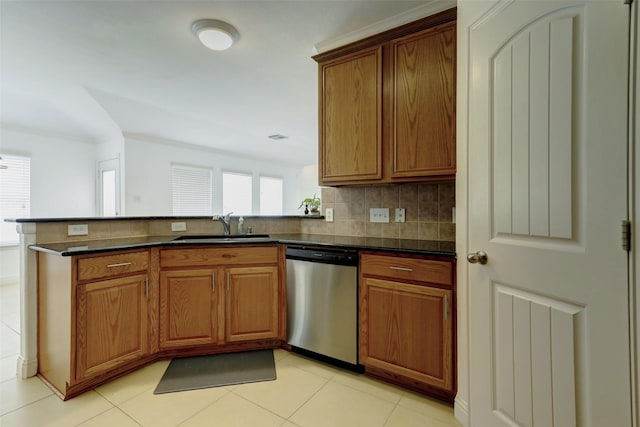 316 Magnolia Way, League City, TX 77573 - kitchen with stainless steel dishwasher, a sink, brown cabinets, and a peninsula