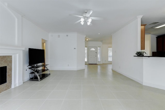 316 Magnolia Way, League City, TX 77573 - living room featuring ceiling fan, a tiled fireplace, light tile patterned flooring, and baseboards