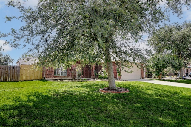316 Magnolia Way, League City, TX 77573 - view of property hidden behind natural elements featuring concrete driveway, brick siding, and a garage