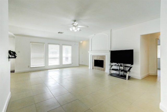 316 Magnolia Way, League City, TX 77573 - unfurnished living room with ceiling fan, light tile patterned floors, baseboards, and a tile fireplace