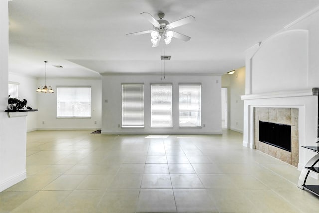 316 Magnolia Way, League City, TX 77573 - unfurnished living room with a ceiling fan, baseboards, light tile patterned floors, a chandelier, and a tiled fireplace