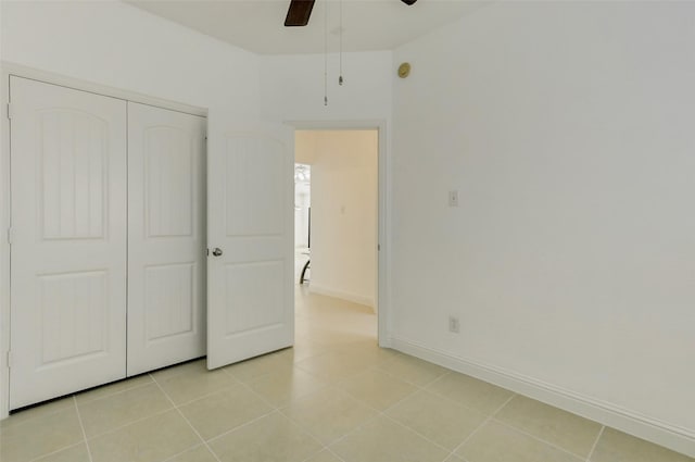 316 Magnolia Way, League City, TX 77573 - unfurnished bedroom with baseboards, a closet, light tile patterned floors, and ceiling fan