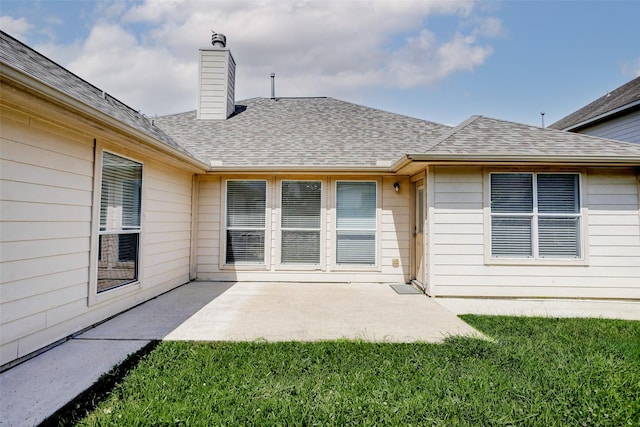316 Magnolia Way, League City, TX 77573 - back of house featuring a lawn, a chimney, a patio area, and a shingled roof